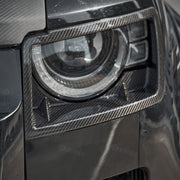 Dry carbon fibre headlight covers installed on Land Rover Defender
