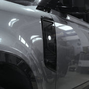 ZHOU'S gloss black side vent covers installed on Land Rover Defender 110