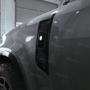 ZHOU'S gloss black side vent covers installed on Land Rover Defender 110