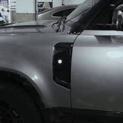 ZHOU'S gloss black side vent covers installed on Land Rover Defender 110