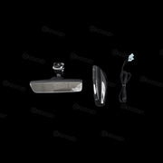 Chrome car mirror and wiring harness on a black background